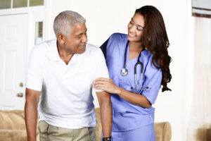 Caregiver assisting senior man with mobility, creating a safe environment for senior citizens.