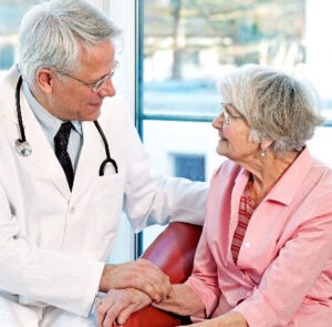 Doctor consoling elderly patient, showing palliative care.