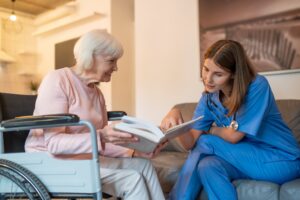 Elderly woman reading with speech therapist. 