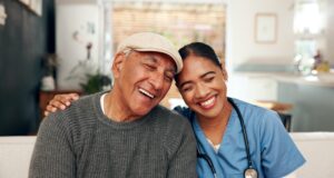 Hospice Patient with nurse while she is visiting his home for a skilled nursing visit.