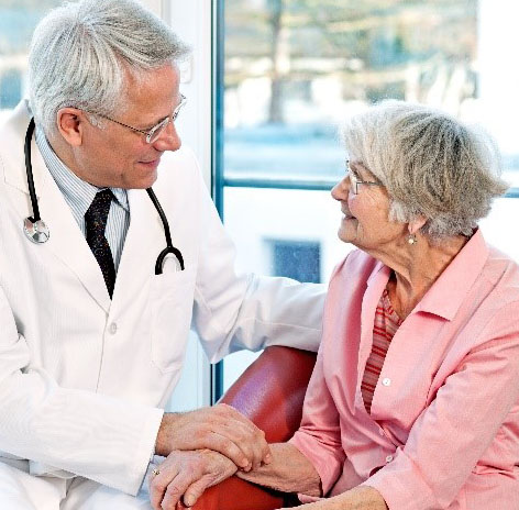 Doctor consoling elderly patient, showing palliative care.